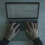 man typing on keyboard