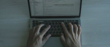 man typing on keyboard