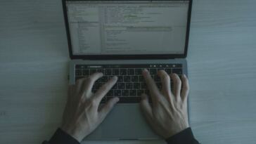 man typing on keyboard